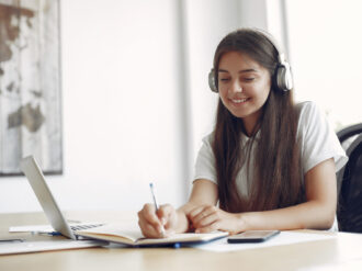 young-student-sitting-table-use-laptop